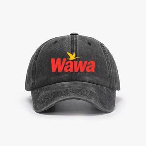 May include: A black baseball cap with a curved peak. The front displays the red word "Wawa" with a yellow bird logo. The cap has a faded, worn look.