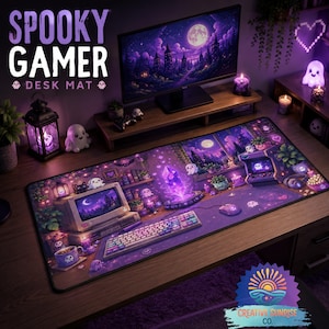 May include: A rectangular desk mat featuring a purple-toned illustration of a gaming setup with a computer, keyboard, mouse, and glowing crystal. The design includes small ghost figures, potted plants, and a moonlit landscape, all set against a dark purple background.