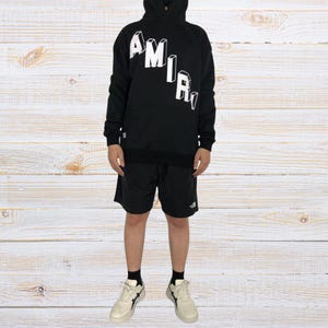 Unisex oversized AMIRI graphic hoodie in black and white streetwear style
