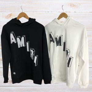 Unisex oversized AMIRI graphic hoodie in black and white streetwear style