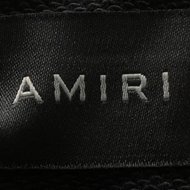 Unisex AMIRI-style hoodies in black and white with bold front graphic and stripe design, pullover streetwear sweatshirts with hood and kangaroo pocket.