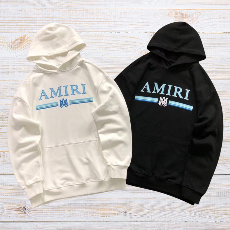Unisex AMIRI-style hoodies in black and white with bold front graphic and stripe design, pullover streetwear sweatshirts with hood and kangaroo pocket.
