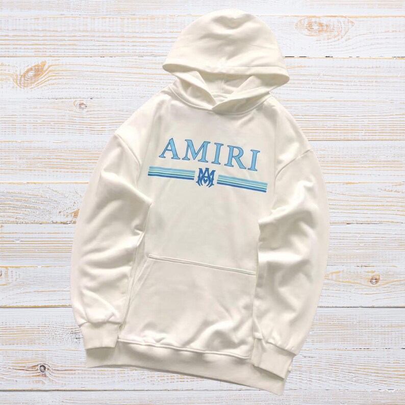 Unisex AMIRI-style hoodies in black and white with bold front graphic and stripe design, pullover streetwear sweatshirts with hood and kangaroo pocket.