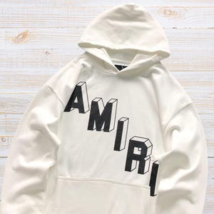 Unisex oversized AMIRI graphic hoodie in black and white streetwear style