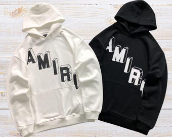 Sudadera con capucha unisex AMIRI con estampado gráfico y corte extragrande.