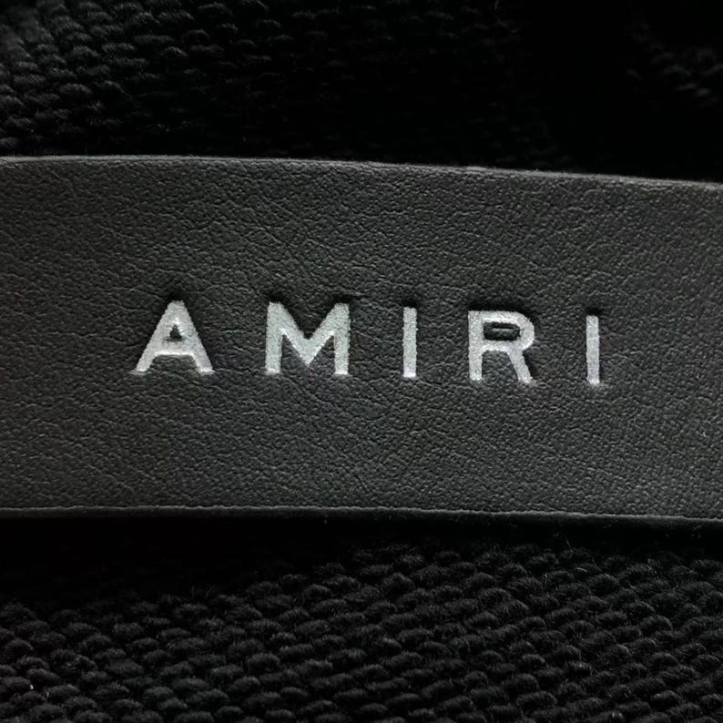 Unisex oversized AMIRI graphic hoodie in black and white streetwear style