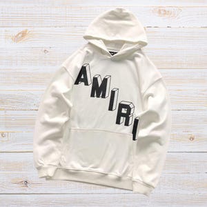 Unisex oversized AMIRI graphic hoodie in black and white streetwear style
