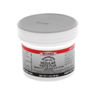 May include: A white plastic jar with a gray lid, labeled "RECTORSEAL NOKORODE REGULAR PASTE FLUX." The jar has a red band and contains 1.7oz (48 grams) of flux. The product meets O.F. 506 and A.A. 51145 standards. Contains lead.