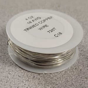 May include: A spool of tinned copper wire, 4 oz, 18 AWG, with the text "Tinned Copper Wire 726T C18" printed on a white label. The wire is silver and tightly wound on a white plastic spool.