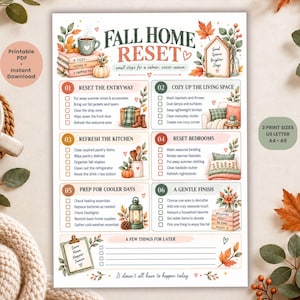 May include: A printable checklist titled Fall Home Reset with six numbered sections for seasonal organization. The document features watercolor illustrations of pumpkins, autumn leaves, a mug, and a lantern, with checkboxes for tasks like resetting the entryway, kitchen, and bedrooms.