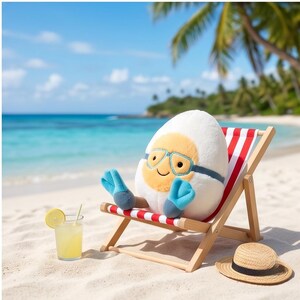 May include: A plush egg character wearing blue goggles and mittens, relaxing in a red and white striped beach chair. A straw hat and a glass of lemonade with a lemon slice sit on the sand near the chair, with a tropical beach and ocean in the background.