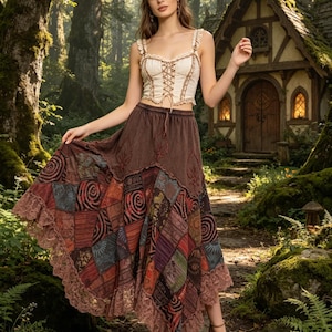 May include: A woman wearing a cream-colored corset top with a brown skirt. The skirt has a patchwork design with various colors and patterns, and a lace trim. The background features a forest and a small cottage.