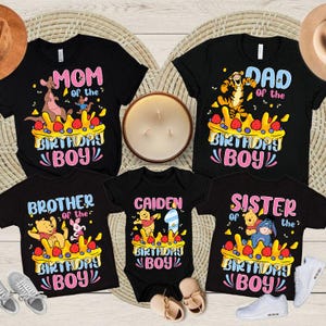 May include: Five black shirts and a baby bodysuit featuring Winnie the Pooh characters, birthday cakes, and text including Mom of the Birthday Boy, Dad of the Birthday Boy, Brother of the Birthday Boy, Sister of the Birthday Boy, and Caiden 1 Birthday Boy.