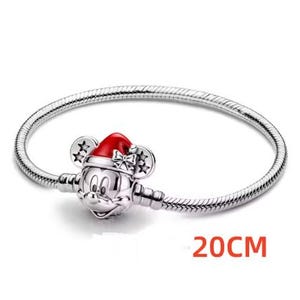 May include: A silver bracelet with a Mickey Mouse charm wearing a red Santa hat. The bracelet is 20cm long.