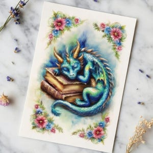 May include: A watercolor illustration of a sleeping blue and green dragon resting on a stack of books. The image is framed with pink and blue flowers. The background is a soft, watercolor wash.