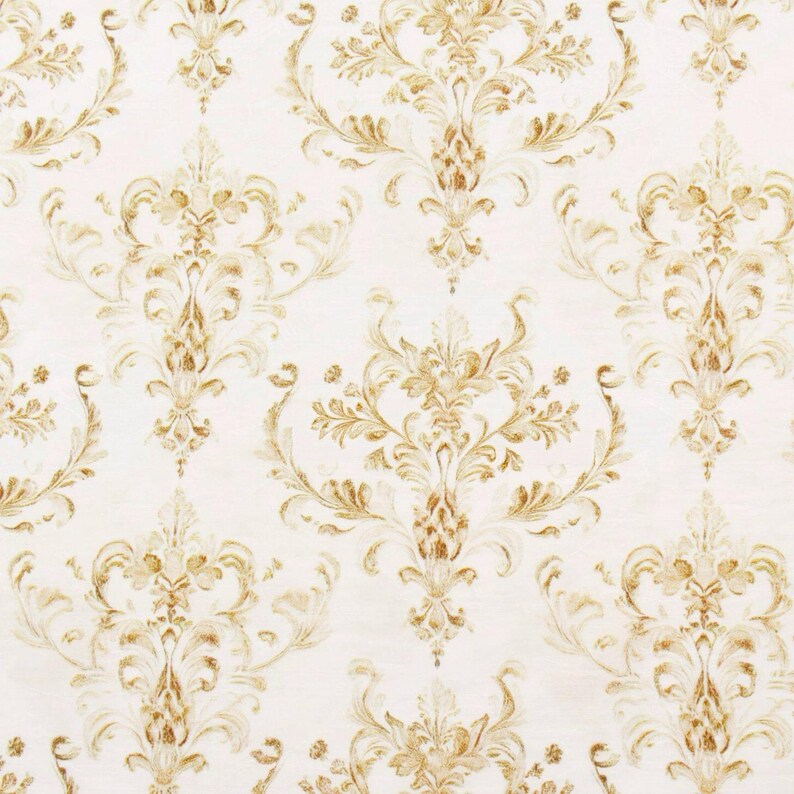 May include: Cream-colored wallpaper with a repeating pattern of ornate, gold-colored floral and scroll designs. The pattern is symmetrical, with large central motifs and smaller, complementary elements filling the spaces.