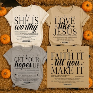 May include: Four t-shirts with inspirational quotes. One is cream-colored with "She is Worthy" in black. Another is tan with "Love Like Jesus". A gray shirt says "Get Your Hopes Up". A tan sign says "Faith It Till You Make It".