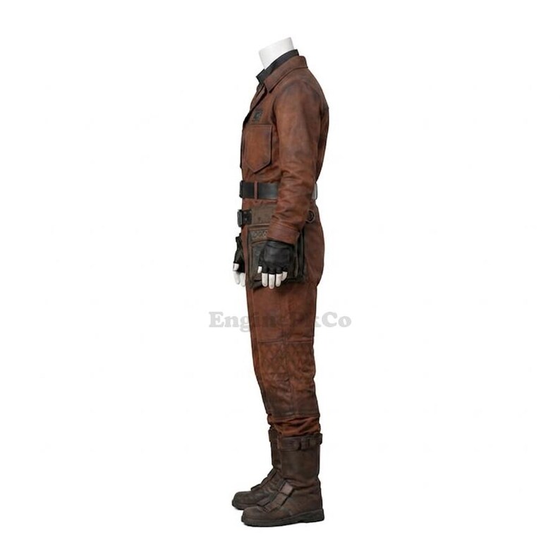 May include: Brown leather jumpsuit with a black belt, gloves, and boots. The outfit includes a utility belt with pouches and a collared shirt. The jumpsuit has a worn, distressed appearance, suggesting a vintage or rugged style.