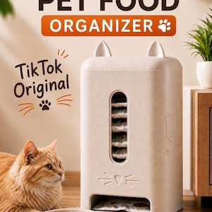 May include: A beige, rectangular pet food organizer with cat-ear-shaped top accents, a vertical viewing window, and a bottom dispensing slot. The unit features embossed cat face details and text reading PET FOOD ORGANIZER and TikTok Original.
