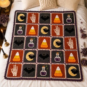 May include: A rectangular crochet blanket featuring a grid of squares with Halloween-themed motifs including orange and yellow candy corn, white skeleton hands, black bats against yellow crescent moons, and purple potion bottles on dark backgrounds.