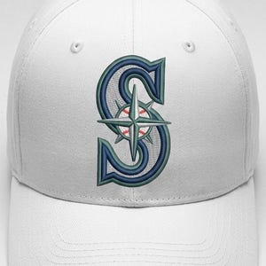 May include: White baseball cap with the Seattle Mariners logo embroidered on the front. The logo is a stylized letter "S" with a compass rose and baseball, in navy blue, teal, and red.