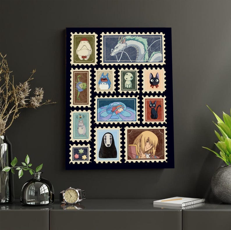 May include: A framed art print featuring a collection of colorful postage stamp designs. Each stamp showcases characters from animated films, including a white dragon, a black cat, and a figure with no face. The stamps are arranged on a dark blue background.