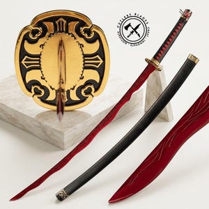 May include: A decorative sword with a red blade and black handle, displayed with a gold and black shield. The blade has a unique pattern, and the handle is wrapped in a red cord. The sword is accompanied by a black scabbard.