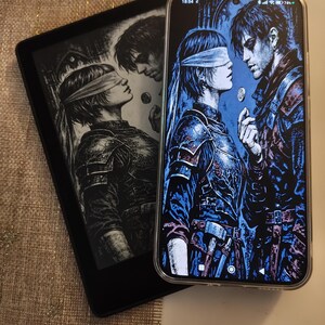 May include: A black e-reader and a smartphone showing the same fantasy artwork. The image depicts a person with a blindfold facing another person. The smartphone has a clear case. The e-reader is on a textured surface.