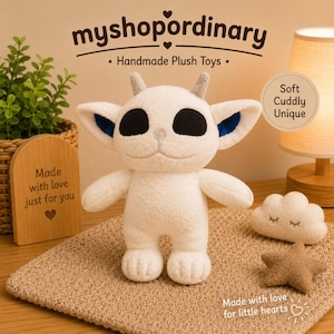 May include: A handmade white plush toy with black eyes, blue-lined ears, and small gray horns. The image also shows a cloud and star plush, and a wooden sign that says "Made with love just for you". The text "myshopordinary" and "Handmade Plush Toys" are also visible.
