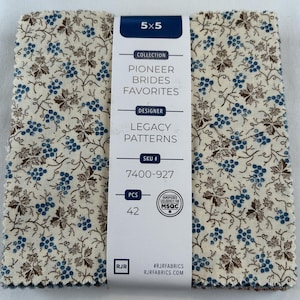 May include: A stack of 5x5 inch fabric squares with a cream background, featuring a repeating pattern of blue berries and brown leaves. The label reads "Pioneer Brides Favorites" and "Legacy Patterns".