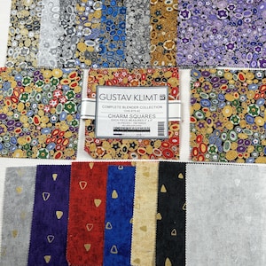May include: A collection of fabric charm squares featuring the Gustav Klimt Complete Blender Collection. The set includes 42 pieces, each measuring 5 inches by 5 inches, with various colorful circular patterns and solid-colored squares with gold triangle accents.