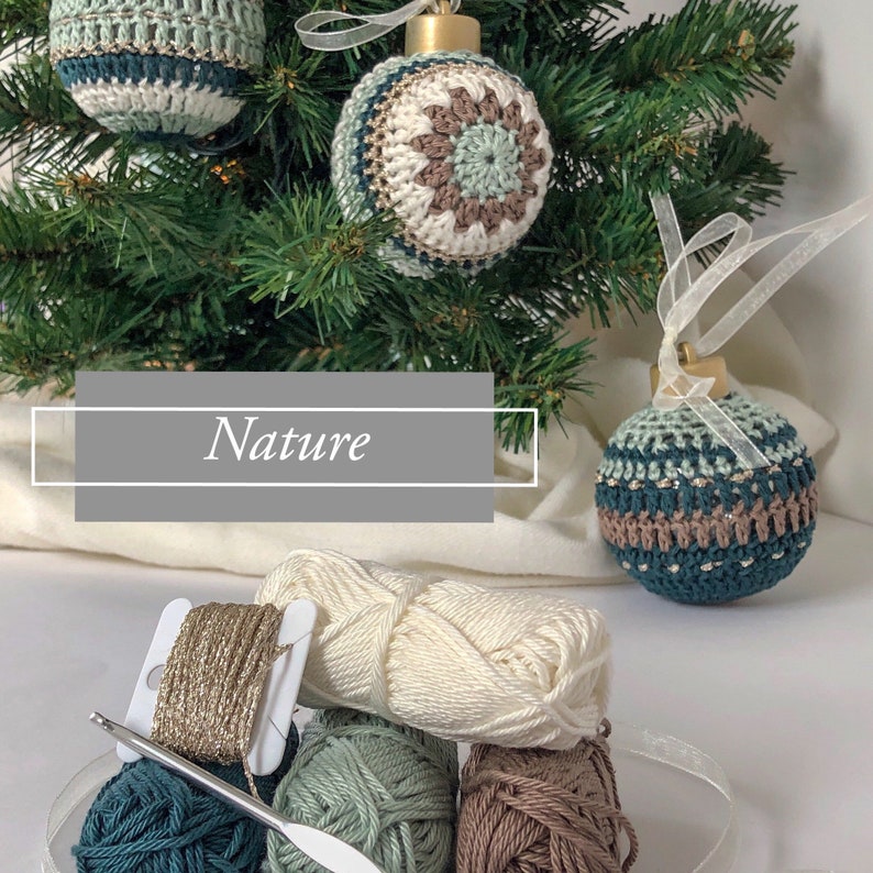 May include: Handmade crochet Christmas baubles in teal, cream, and brown hang on a green Christmas tree. The word "Nature" is displayed in a grey box. Balls of yarn and a crochet hook are in the foreground.