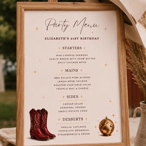 May include: A framed party menu sign for Elizabeth's 21st birthday, featuring text in black and brown, decorated with gold star icons, a pair of red cowboy boots, and a gold disco ball. The sign is displayed on a wooden easel with a hat.