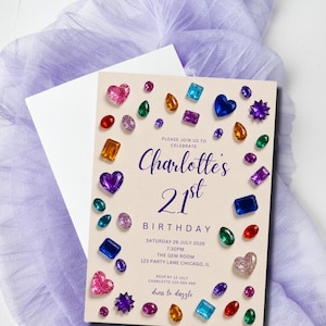 May include: A rectangular birthday invitation card on a light cream background featuring a border of colorful, multi-shaped gemstone illustrations. The text reads: Please join us to celebrate Charlotte's 21st Birthday, Saturday 26 July 2026, 7:30PM, The Gem Room, 123 Party Lane Chicago, IL, RSVP by 12 July Charlotte 123-555-456, dress to dazzle.