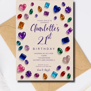 May include: A rectangular birthday invitation card on a tan envelope featuring a cream background with scattered colorful gemstone illustrations. Text reads: PLEASE JOIN US TO CELEBRATE Charlotte's 21st BIRTHDAY SATURDAY 26 JULY 2026 7:30PM THE GEM ROOM 123 PARTY LANE CHICAGO, IL RSVP BY 12 JULY CHARLOTTE 123-555-456 dress to dazzle.