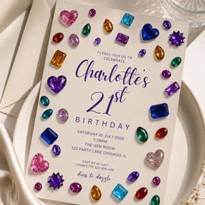 May include: A cream-colored birthday invitation card featuring a scattered pattern of colorful, multi-shaped gemstone illustrations. The text reads: Please join us to celebrate Charlotte's 21st Birthday, Saturday 26 July 2026, 7:30PM, The Gem Room, 123 Party Lane Chicago, IL, RSVP by 12 July Charlotte 123-555-456, dress to dazzle.