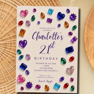 May include: A rectangular invitation card with a cream background featuring scattered colorful gemstone illustrations in various shapes like hearts, ovals, and squares. The text reads: Please join us to celebrate Charlotte's 21st birthday, Saturday 26 July 2026, 7:30pm, The Gem Room, 123 Party Lane Chicago, IL, RSVP by 12 July Charlotte 123-555-456, dress to dazzle.