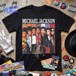 May include: A black short-sleeve t-shirt featuring a graphic print of Michael Jackson in various iconic outfits arranged in vertical panels. The text MICHAEL JACKSON is printed in white above the panels, with a gold signature below the images.