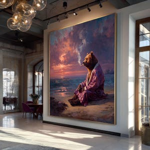 May include: Large framed painting of a bear in a purple robe smoking a cigarette, seated on a beach at sunset. The artwork features a vibrant sky with shades of orange, pink, and purple, and a calm ocean.