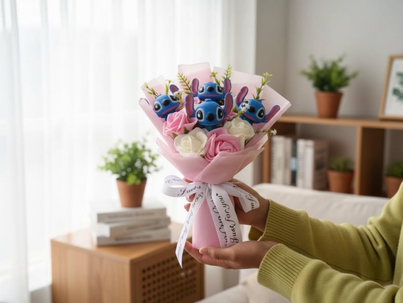 May include: A bouquet featuring blue character figures with large ears, pink and white roses, and greenery, wrapped in pink paper and tied with a white ribbon. The ribbon reads "Just for you."