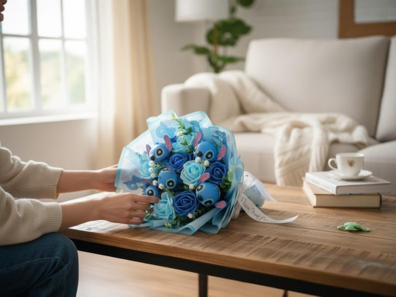 May include: A bouquet of blue and light blue flowers and character figures wrapped in blue cellophane. The bouquet is tied with a white ribbon. The bouquet is on a wooden table.