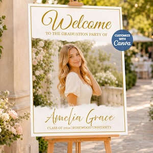 May include: A rectangular graduation party welcome sign on a wooden easel. The sign features gold text reading Welcome to the graduation party of Amelia Grace, Class of 2026, Rosewood University, and a central photograph of a person with long blonde hair.