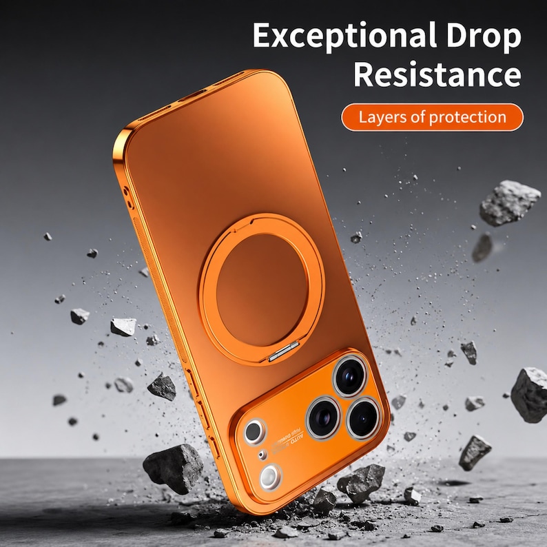 May include: Orange phone case with a gold-colored frame and a circular ring holder. The case has a camera cutout and the text "Exceptional Drop Resistance" and "Layers of protection". The phone case is shown with rocks around it.