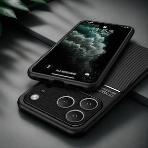 May include: Two black smartphones, one on top of the other. The top phone displays a lock screen with the time 11:53. The bottom phone has a textured back with three camera lenses and the text "IOS DESIGN BEST OF YOURS".
