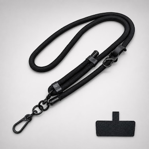 May include: A black rope lanyard featuring a braided cord design with black plastic connectors and a metal lobster clasp. The set includes a separate black rectangular adhesive tab with a small vertical extension for attachment purposes.