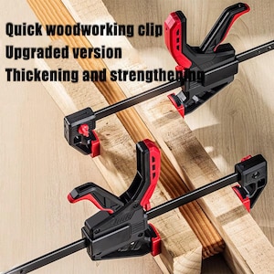 May include: Two black and red woodworking clamps are shown, gripping wooden planks. The clamps have a quick-release mechanism and are designed for woodworking projects. Text on the image reads "Quick woodworking clip, Upgraded version, Thickening and strengthening."