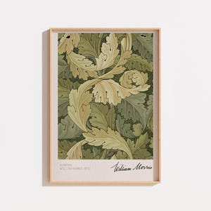 Peut inclure: Une impression d'art encadrée présentant le motif Acanthus de William Morris. Le design affiche des feuilles d'acanthe complexes, tourbillonnantes, de couleur crème clair et vert sauge sur un fond vert foncé. Le texte indique Acanthus William Morris 1875.