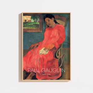 May include: A framed art print featuring a painting of a person in a long red dress sitting in a wooden rocking chair. The background includes a blue wall and a small framed landscape painting. The text PAUL GAUGUIN 1848-1903 is printed in white.