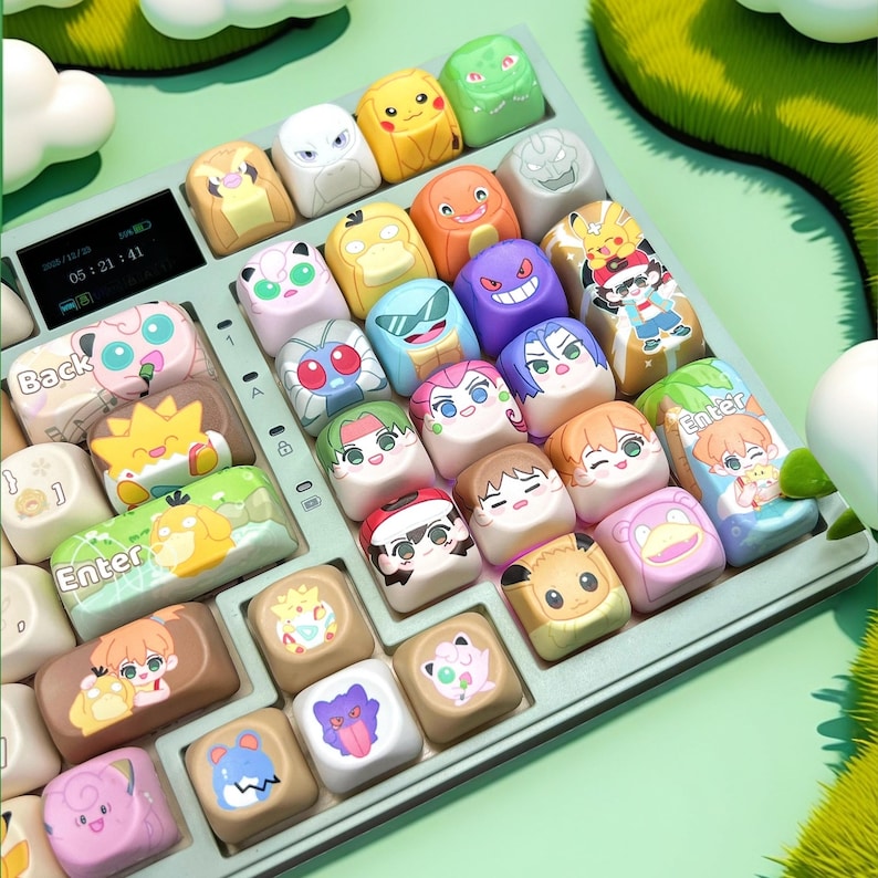 May include: A keyboard with custom keycaps featuring colorful cartoon character designs. The keycaps are square and have various characters on them. The keyboard has a digital display and a green and white color scheme.