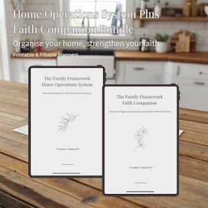 May include: Two digital tablets on a wooden table display the text "Home Operations System Plus Faith Companion Bundle". The tablets show the text "The Family Framework" and "Printable & Fillable PDF". One tablet has a botanical illustration.